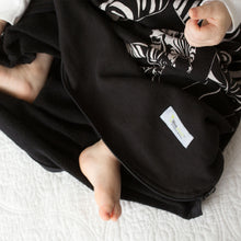 Load image into Gallery viewer, Cozy Basics Sleep Bag Black / Zebras baby with feet out the bottom