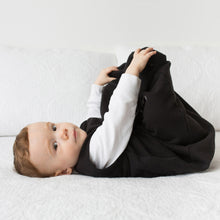 Load image into Gallery viewer, Cozy Basics Sleep Bag Black / Zebras Baby with feet up Lifestyle