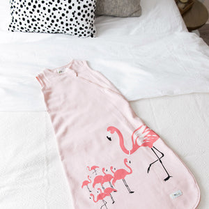 Cozy Basics Sleep Bag Pink / Flamingos laid out on Bed